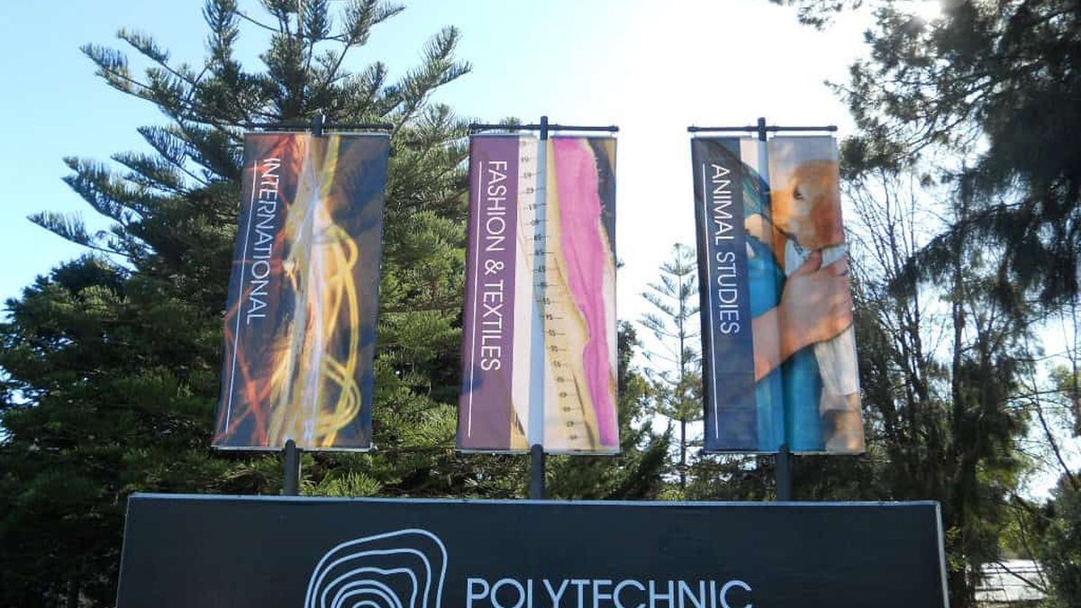 Printed fabric display flags mounted on poles at a Perth campus entry